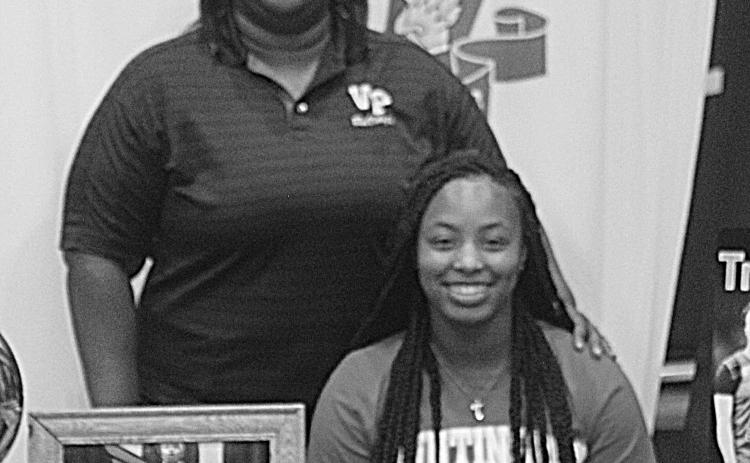 The former Ville Platte Lady Bulldog star Trinity Leday (seated) is pictured with her coach Rhonda Thomas (standing). (Gazette photo by Rhett Manuel)