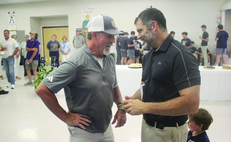 Robert Soileau (left), the son of Bobby Soileau, meets with Derek Landry (right), the grandson of RP “Cow” Landry and new head football coach and athletic director at Sacred Heart. (Gazette photo by Tony Marks)