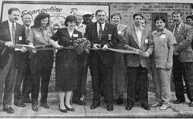 NEW 911 CENTER ONLINE - 911 Director Liz Hill and Sheriff Wayne Morein (front center cutting the ribbon) were among those celebrating the Evangeline Parish 911 system going online with a ribbon cutting and tour of the facility. Also among those pictured are District Attorney Brent Coreil and Clerk of Court Walter Lee. (Gazette archive photo)