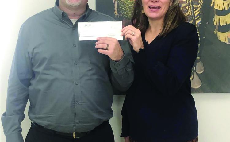 Donation is presented for Mardi Gras Social