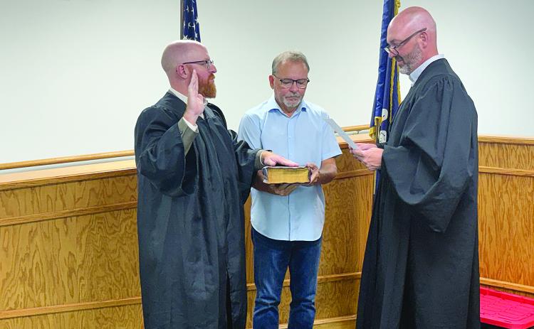 Christopher Ludeau (left) takes the oath of office after being appointed as magistrate of the Village of Pine Prairie. Administering the oath during the village council meeting held Thursday, September 10, is Ville Platte City Court Judge and Village of Pine Prairie Attorney Gregory Vidrine (right). Holding the Bible is Pine Prairie Mayor Quint West (center).