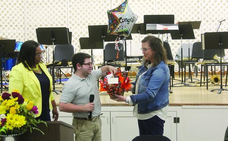 Pine Prairie Principal Alice Lejeune (right) presents a gift basket to Nicholas Stelly (center) in recognition of him being named Outstanding Work Based Student of the Year. Also pictured is Transition Specialist Dot Doulet (left). (Gazette photo by Tony Marks)