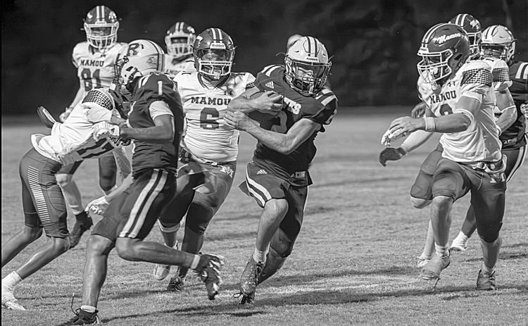 Members of the Mamou defense including Neahemiah Freeman (17) and Decoreyon Arceneaux (6) try to take down a Rayne ball carrier in a game last Friday night. (LSN photo by Lisa Soileaux)