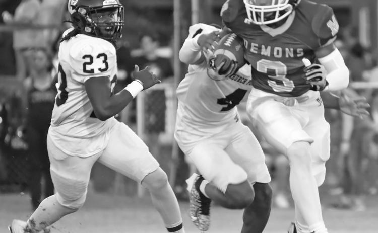Zamurri Brown (3) sets his eyes on picking up a chunk of real estate for Mamou despite being pursued by a couple of Church Point defenders. (LSN photo by Chris Quebedeaux)