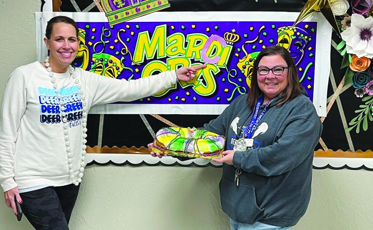 MARCI GRAS IN OKLAHOMA - Prairie Vale Elementary congratulated Dr. Marcy Boudreaux-Johnson after she was named District Teacher of the Year with a special “Marci Gras” celebration, complete with king cake and a parade down the school halls to Mardi Gras music. Boudreaux-Johnson is shown with Prairie Vale Elementary School administrator Michelle Anderson (left). (Photo courtesy of Dr. Marcy Boudreaux-Johnson)