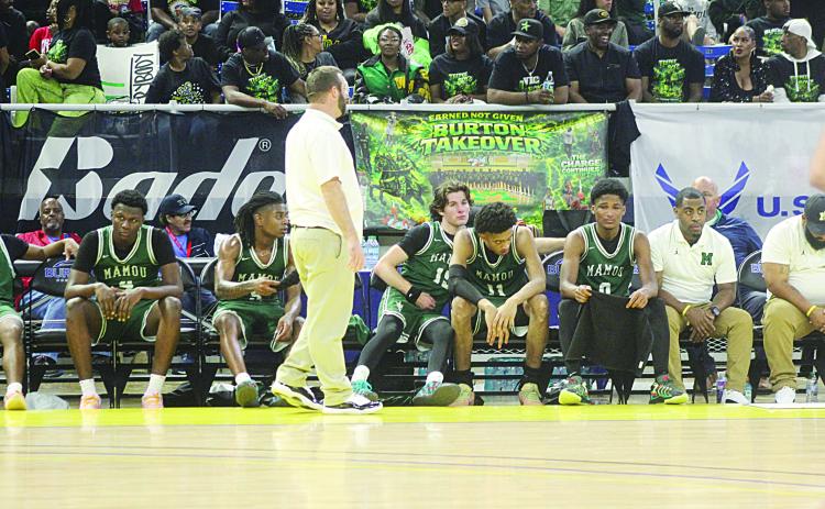 Mazzo Matteo (15) consoles Ernest Dugas (0) towards the end of Mamou’s loss to Marksville in the state semifinals on Wednesday night. Pictured between them is Braxton Ardoin (11), and standing is head coach Jaenne Fontenot. (Gazette photo by Tony Marks)