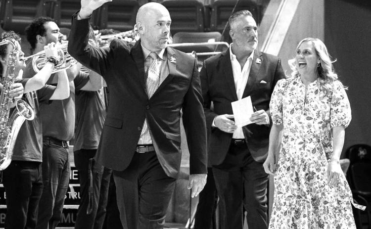 McNeese men’s basketball coach Bill Armstrong walks onto the floor of the Legacy Center for his introductory press conference. (Photo courtesy of McNeese Athletics)