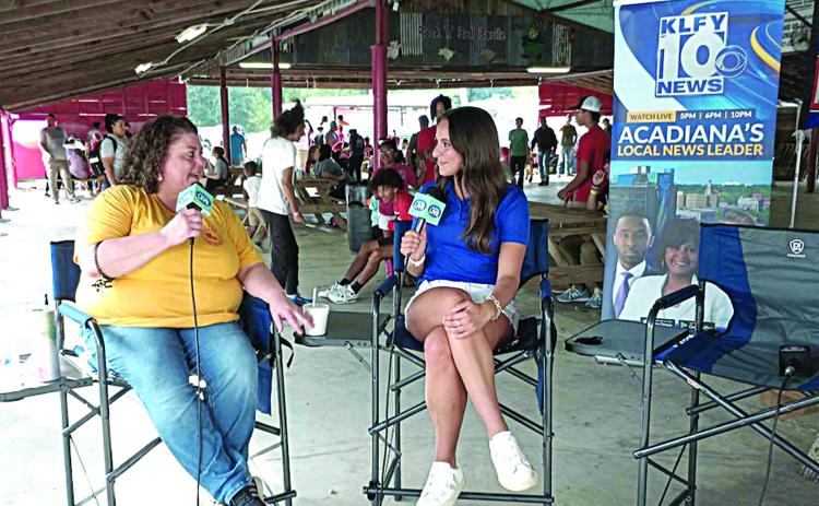 SPREADING THE WORD - Melissa Clavier (left) visits with Lidia Alcala of KLFY-TV 10 under the Pig Barn at this year’s La. Swine Festival. The Lafayette station was live at the festival on Friday, November 1, to share the schedule and the history of the festival with all of Acadiana. (LSN photo by Darrel LeJeune)