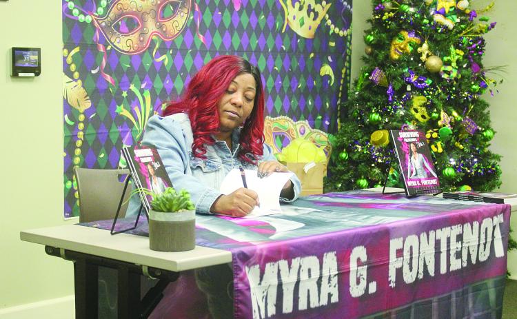 Myra Fontenot is pictured as she signs a copy of her new book Surviving Frenemies. The book signing was held on Saturday, January 11, at the main branch of the Evangeline Parish Library in Ville Platte. (Gazette photo by Tony Marks)