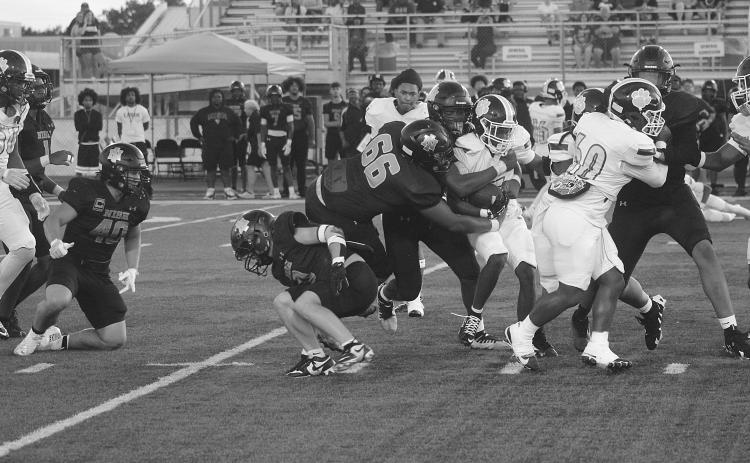 Kaiden Freeman (60) provides running room for Kendarius Doucet (15) as he finds running room against the New Iberia Senior High Yellow Jackets last Friday night. (Gazette photo by Tony Marks)