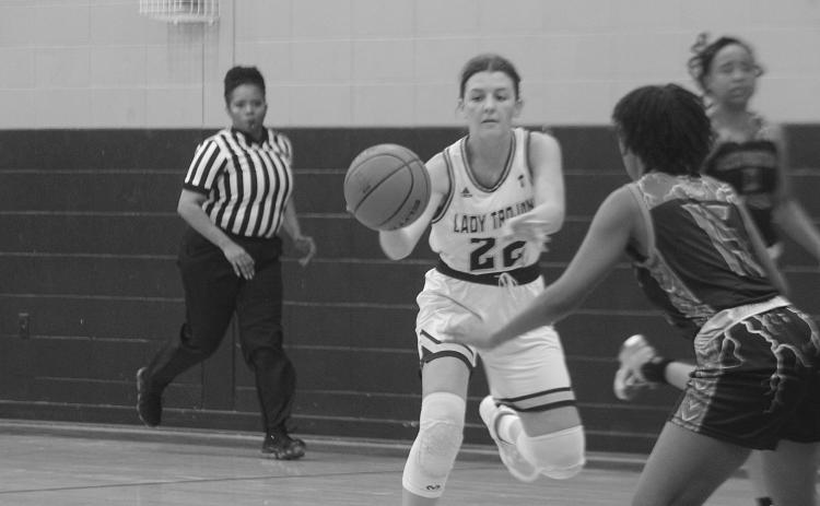 Lady Trojans’ Kali Shiver (22) looks to pass the basketball down the court in her team’s win against North Central. (Gazette photo by Rhett Manuel)