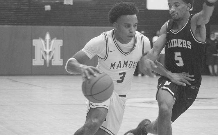 Zamaurri Brown (3) moves the basketball toward Mamou’s goal in the Green Demons’ 69-45 home loss against Northwest last Friday night. (Gazette photo by Tony Marks)