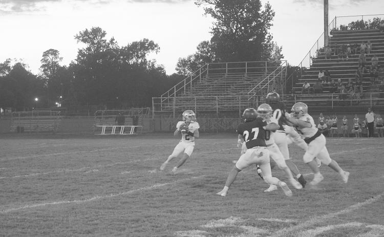 Sacred Heart quarterback Ellis Fusilier (2) drops back in the pocket and looks to deliver a pass in Trojans’ 42-0 loss against the Opelousas Catholic Vikings to begin district play. (Gazette photo by Tony Marks)