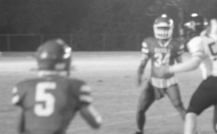 Christian Guillory (34) looks to complete a pass to Landon Johnson (5) during Basile’s win over Oberlin. (Gazette photo by Tony Marks)