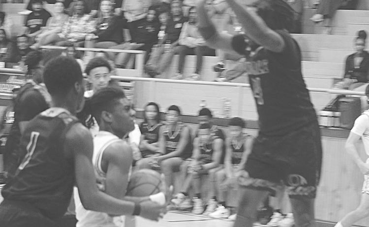 Oakdale’s Brandon Baker Guidry (4) goes up to block a shot from Mamou’s Jamison Viltz in Oakdale’s 74-52 loss last Friday night. (Gazette photo by Tony Marks)