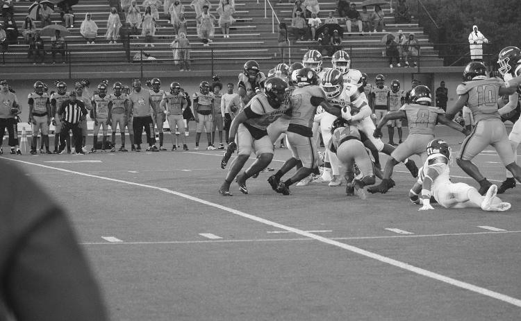 Mamou’s Zamaurri Brown (3) fights for additional yardage in the Green Demons’ 56-0 loss to Opelousas Thursday night. (Gazette photo by Tony Marks)