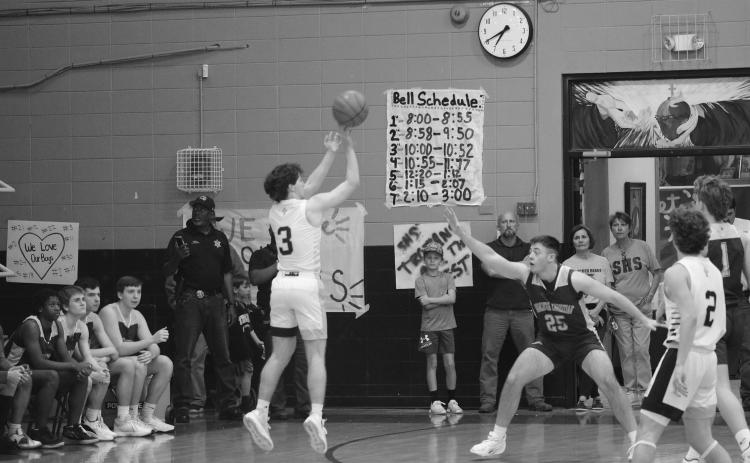 Gabe Fontenot (3) shoots the basketball from beyond the arc. Fontenot’s Trojans closed out the game with a win  before ending the season with a loss against Southern Lab in the second round of the playoffs. (Gazette photo by Tony Marks)