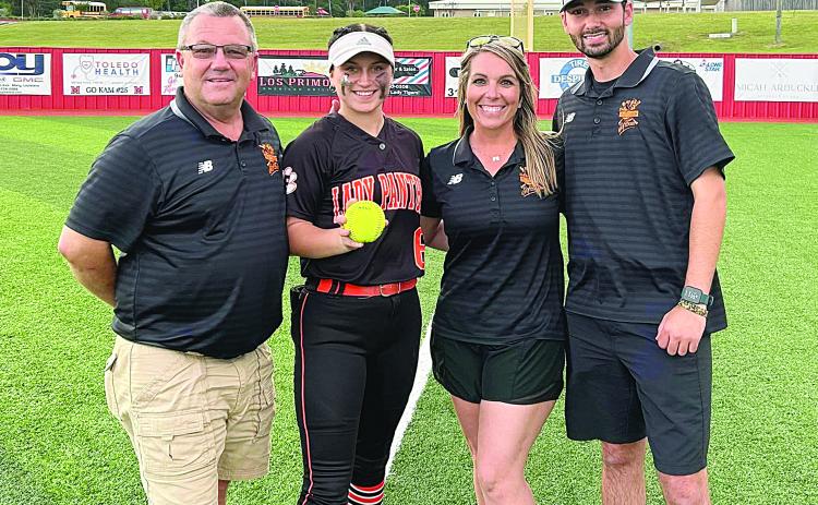 Pine Prairie Lady Panther Camron Lafleur delivered a two-run home run in the top of the seventh inning that sent her team past Many and into the quarterfinal round against the winner of the game between Sterlington and Pine. From left are assistant coach Craig Whittington, Lafleur, head coach Alycia Hebert, and assistant coach Hunter Arnaud. (Photo courtesy of Pine Prairie High School Softball)