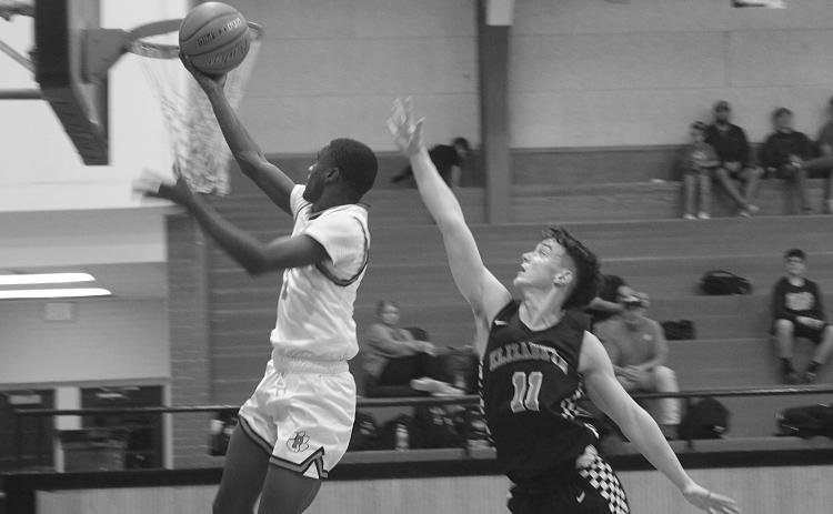 With Elizabeth’s Owen Soileau (11) not far behind, Pine Prairie’s Da’Jon Lemalle (1) scores a basket in his team’s 55-53 loss at home Tuesday night. Lemalle finished the game with 19 points to lead the Panthers. (Gazette photo by Tony Marks)