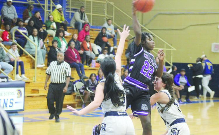 Brileyah Freeman (22) looks to pass the basketball to a Lady Bulldog teammate while being defended by Sacred Heart’s Olivia Tate (13) and Riley St. Cyr (34) in Ville Platte’s 51-38 win to open up the parish tournament.