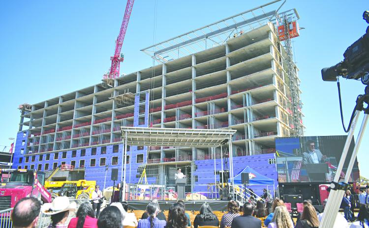 In the left photo, guests watch as the final beam was installed on the construction site of the new hotel being built at Coushatta Casino Resort.