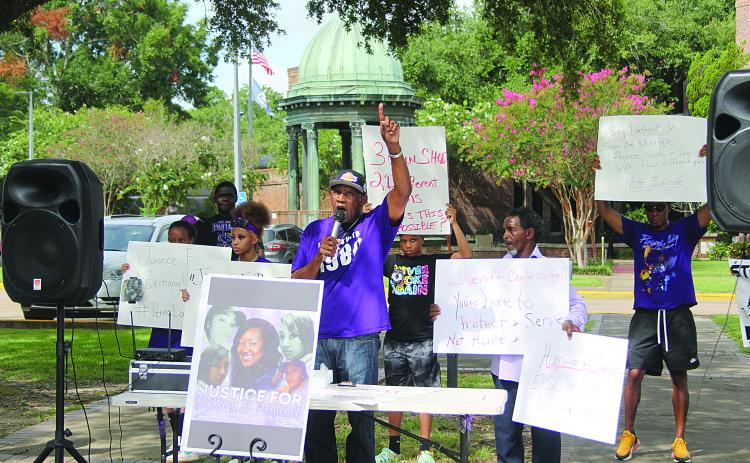 JULY 16 - Family members and friends of Brittany Fontenot are pictured as they gather for a peaceful protest at the courthouse. In the center is Hamilton Frank, an uncle of the victim. (Gazette photo by Tony Marks)