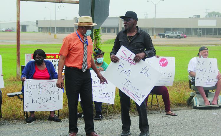 Ville Platte City Councilman Lionel Anderson (left) discusses issues with one of the protest organizers Donald Anderson (right) at the event held outside of the Cleco office in Ville Platte. (Gazette photo by Tony Marks)