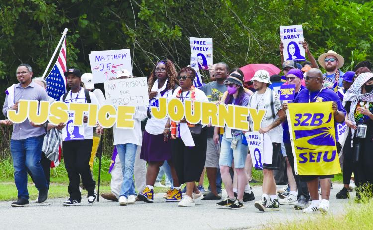Protesters gather outside the GEO South Louisiana Detention Center in Basile on Monday, June 30. Among them were Joseph Bryant, international executive director of Service Employees International Union (SEIU).   (Photo by Robert Stewart of Verite News)