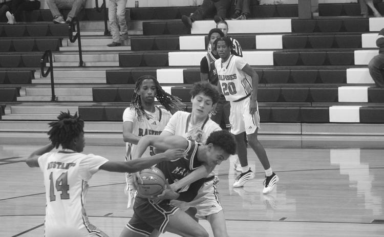 Braxton Ardoin (11) fights through traffic to collect a basket for Mamou in the Green Demons’ 70-40 win over Rapides last season. (Gazette photo by Tony Marks)