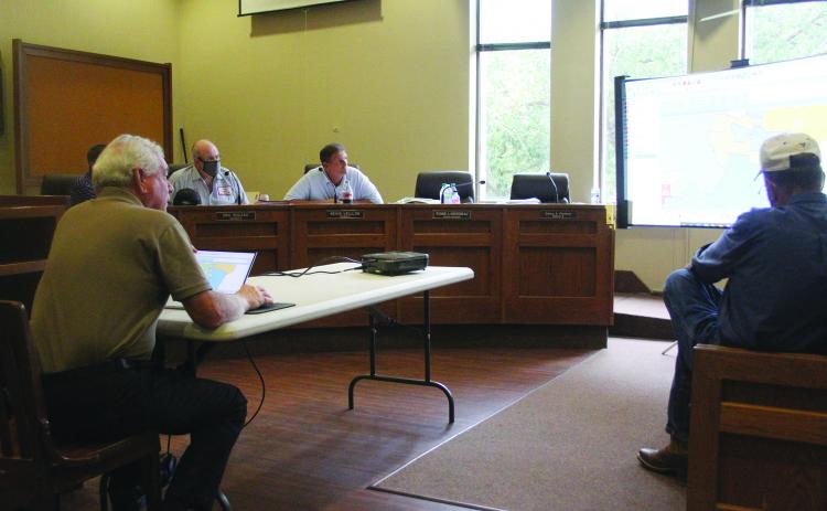 Demographer Mike Hefner (seated on the left) presents a proposed reapportionment plan to the Evangeline Parish Police Jury. Jurors pictured (from left) are Ryan Ardoin, Eric Soileau, Kevin Veillon, and Sidney Fontenot. (Gazette photo by Tony Marks)