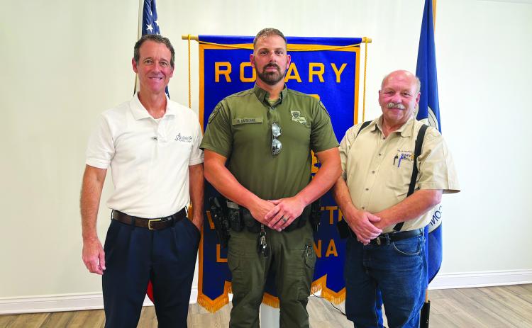 CHANGES IN HUNTING AND FISHING REGULATIONS DISCUSSED -  Corporal Mike Darbonne with the LDWF (center) shared several changes  to the 2024-2025 state hunting and fishing regulations. He is shown with Rotarian Richard LeJeune (left) and Rotary President Bob Manuel (right). (Gazette photo by Heather Bogard)