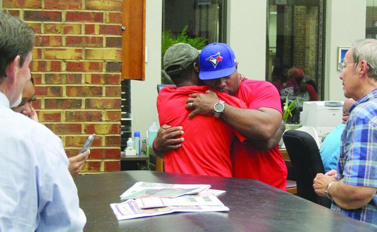 Ville Platte Mayor-Elect Ryan Leday Williams (center right) embraces a supporter as the election results are announced inside the Evangeline Parish Clerk of Court’s Office on Tuesday, November 8. (Gazette photo by Tony Marks)