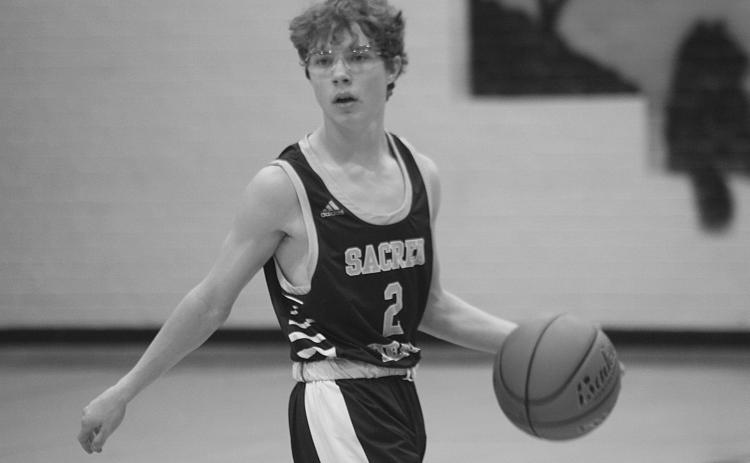 Hayden Deshotel (2) moves the basketball down the court against Mamou in a game played during the parish tournament earlier this season. (Gazette photo by Rhett Manuel)
