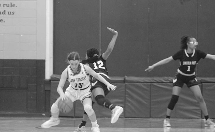 Ava Johnson (15) spins around a Lincoln Prep defender in Sacred Heart’s 58-21 disposal of the Lady Panthers in the opening round of the Select Division IV playoffs. The Lady Trojans now travel to Delta Charter for their second round matchup on Monday. (Gazette photo by Rhett Manuel)