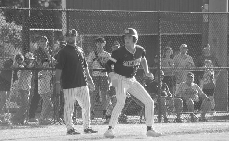 Sully Manuel (13) eyes home plate as he takes his lead off the third base bag during Sacred Heart’s 3-2 playoff loss to St. Edmund on Sunday, May 3. (Gazette photo by Tony Marks)