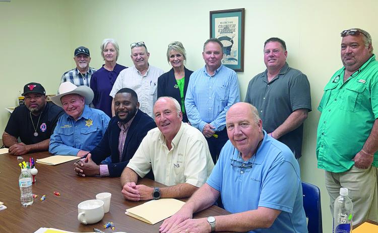 From left are (standing) Turkey Creek Mayor Bert Campbell, Evangeline Parish School Board member Karen Vidrine, Evangeline Parish Secretary-Treasurer Dirk Deville, Mamou Mayor Leisa Deshotel, Pine Prairie Mayor Quint West, Basile Mayor Mark Denette, and Chataignier Mayor Justin Darbonne; (sitting) Ville Platte Mayor Ryan LeDay Williams, Evangeline Parish Sheriff Charles Guillory, incoming administrator Cody Jones, outgoing administrator Marty Morein, and Evangeline Solid Waste Commission Executive Director