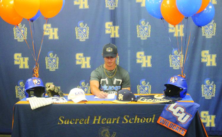 Sam Veillon, formerly of Sacred Heart, is pictured as he signs to play baseball at Louisiana Christian University during a  ceremony held Wednesday, July 2. (Gazette photo by Tony Marks)