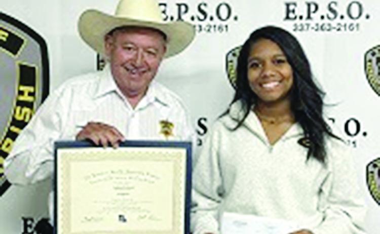 Evangeline Parish Sheriff Charles Guillory is pictured on the left as he presents an academic scholarship to Jaidan Richard, of Mamou. (Photo courtesy of EPSO)