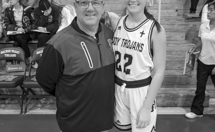 Kali Shiver (right) is pictured with her head coach Craig Whittington (left) after collecting the 1 thousandth point of her career as a Sacred Heart Lady Trojan. (Gazette photo by Rhett Manuel)