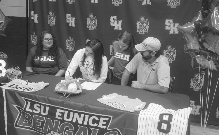 Amelia Fontenot (center), of Sacred Heart High School, is pictured as she signs to play softball at LSU-E. Pictured on the left is her mother, Rebecca, and on the right is her father, Lance. Also pictured is her sister, Eloise. (Gazette photo by Tony Marks)