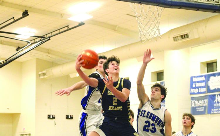 Sacred Heart guard Ellis Chapman goes up for a layup in last Friday’s 60-44 win over St. Edmund. The Trojan boys and girls split their games with the Blue Jays in District 5-1A play. (LSN Photo by Rhett Manuel)