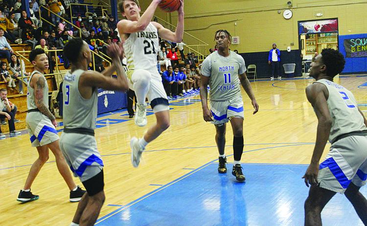 Austin Darbonne (21) goes for a basket against North Central. In the game against the Hurricanes, he recorded his 1,000th career point. (Gazette photo by Rhett Manuel)