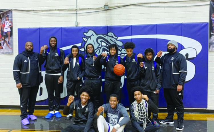 Pictured with their coaches are members of the Ville Platte High boys’ basketball team that won the District 5-3A championship. In no particular order are Davonte Fontenot, Jaquan Lavergne, Jamarre Byers, Tauj Roy, Montavius Seraille, Taylin Richard, Jakhalan Slaughter, Troas Murray, Latelldrick Prejean, Sage Papillion, Michael Berry, and Latrayvion Thomas. (Photo courtesy of VPHS)