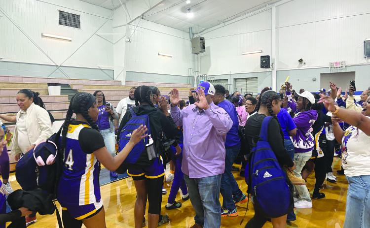 Ville Platte Mayor Ryan LeDay Williams (center) greets Donashia Jack (14) on the court after the 5th seed Ville Platte Lady Bulldogs pulled off an upset against 4th seed Springfield in the quarterfinals. With the win, Ville Platte advanced to the girls’ basketball state semifinals. (Gazette photo by Tony Marks)