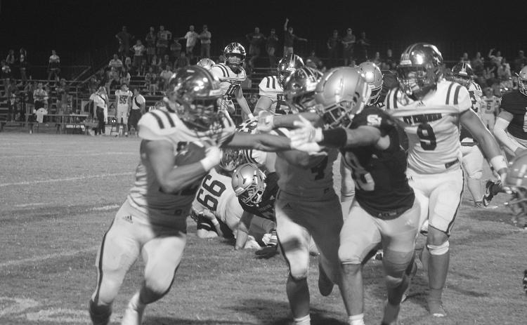 Drew Mayeaux (28) tries to force a St. Edmund ball carrier out of bounds in Sacred Heart’s 58-36 home loss last Friday. (Gazette photo by Tony Marks)