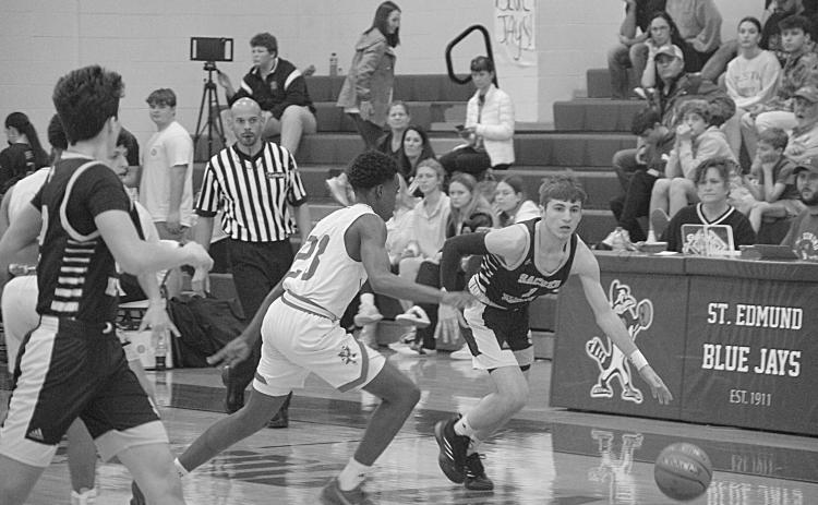 Elliot Fontenot (1) drives down the court past a Lacassine defender in Sacred Heart’s 74-48 loss in the finals of the Kendall and Brad Fontenot Memorial Shootout. (LSN photo by Rhett Manuel)