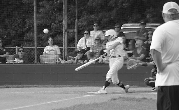 Sacred Heart flex player Jenna Veillon (6) connects with a pitch in the Lady Trojans’ 11-1 win over St. John in the second round of the Division IV Select softball playoffs. (Gazette photo by Rhett Manuel)