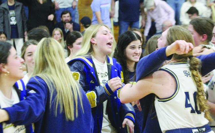 Members of the Sacred Heart Lady Trojan basketball team, including Taylor Darbonne, Olivia Tate, Ava Johnson, and Rose Ardoin, celebrate after advancing to the state semi-finals in Hammond. (Gazette photos by Rhett Manuel)