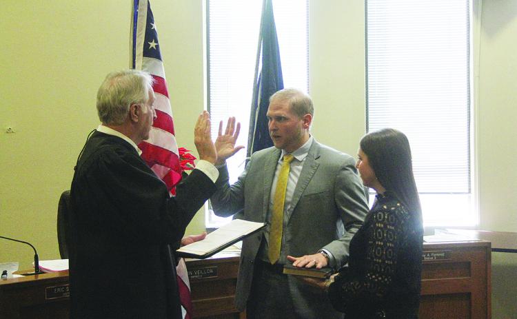 J. Stanford Vidrine (center) takes the oath of office as assistant district attorney from Judge Gary Ortego (left). Pictured on the right holding the Bible is Vidrine’s wife, Brittany. (Gazette photo by Tony Marks)