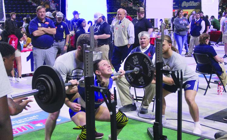 Pictured on the left is Sacred Heart’s Lily Deshotel as she squats on Thursday. (Gazette photo by Tony Marks)